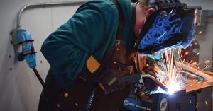 Welder working with equipment electrically connected by MELTRIC plug and receptacle.
